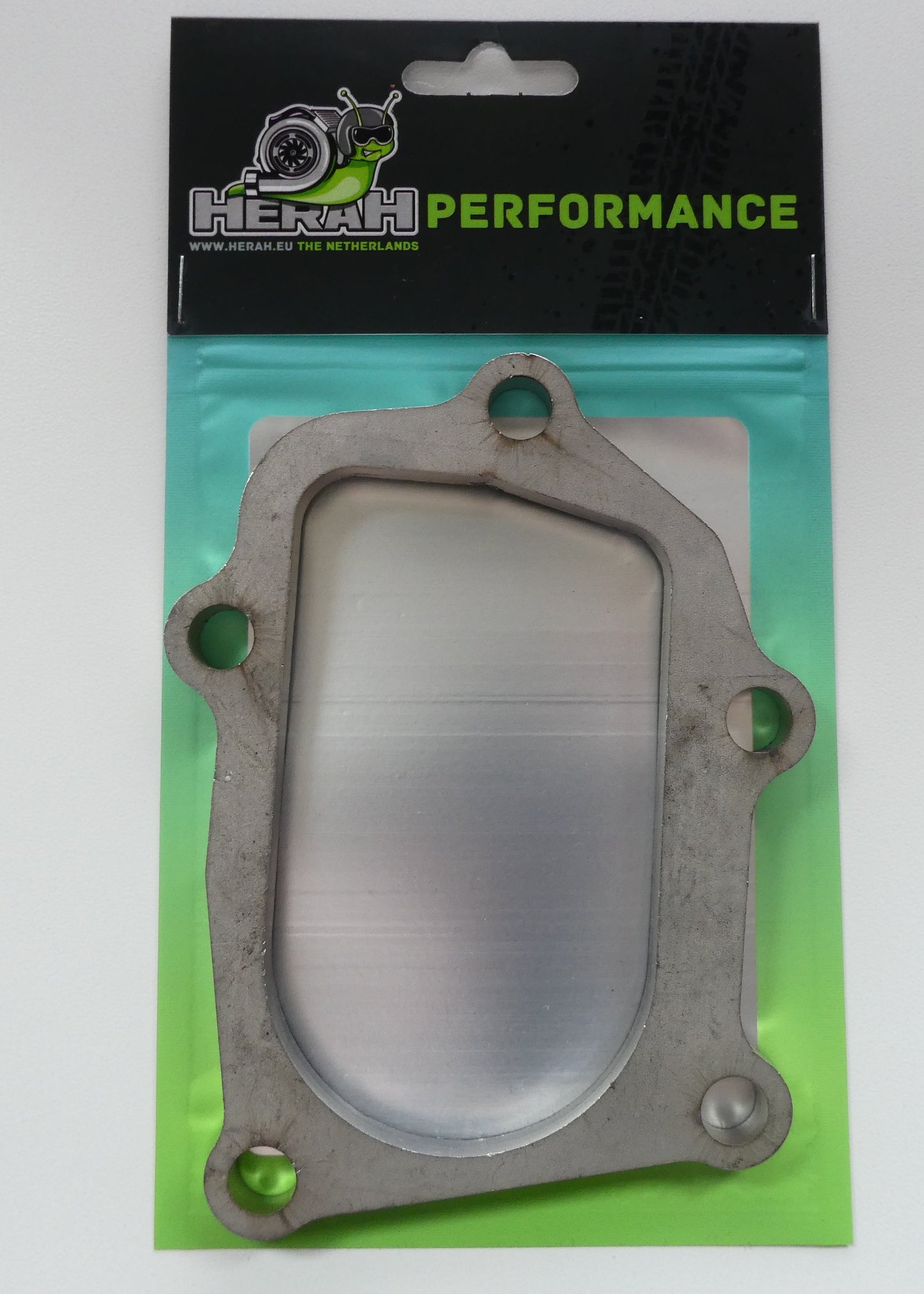 Metal gasket on a green and black 'HERAHPERFORMANCE' branded packaging