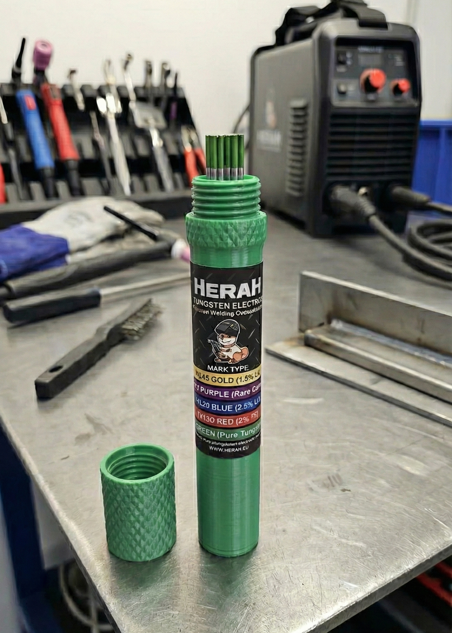 Green cylindrical product with tig tungsten 'HERAH' branding on a workshop table.